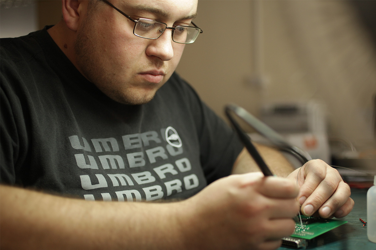 Man working on relay testing equipment