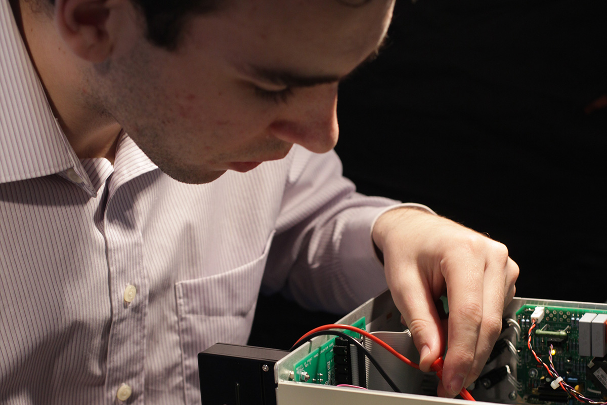 Man working on relay testing equipment